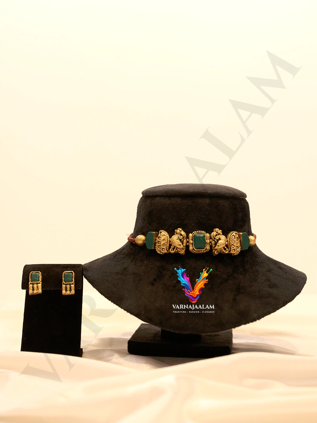 Handcrafted terracotta choker necklace set featuring antique gold peacock motifs, square dark green stones, and matching square stud earrings