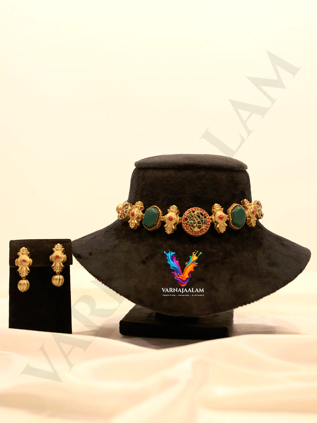 Handcrafted antique gold terracotta choker necklace featuring a round peacock center medallion, hexagonal emerald green stones, gold motif connectors, and matching drop earrings