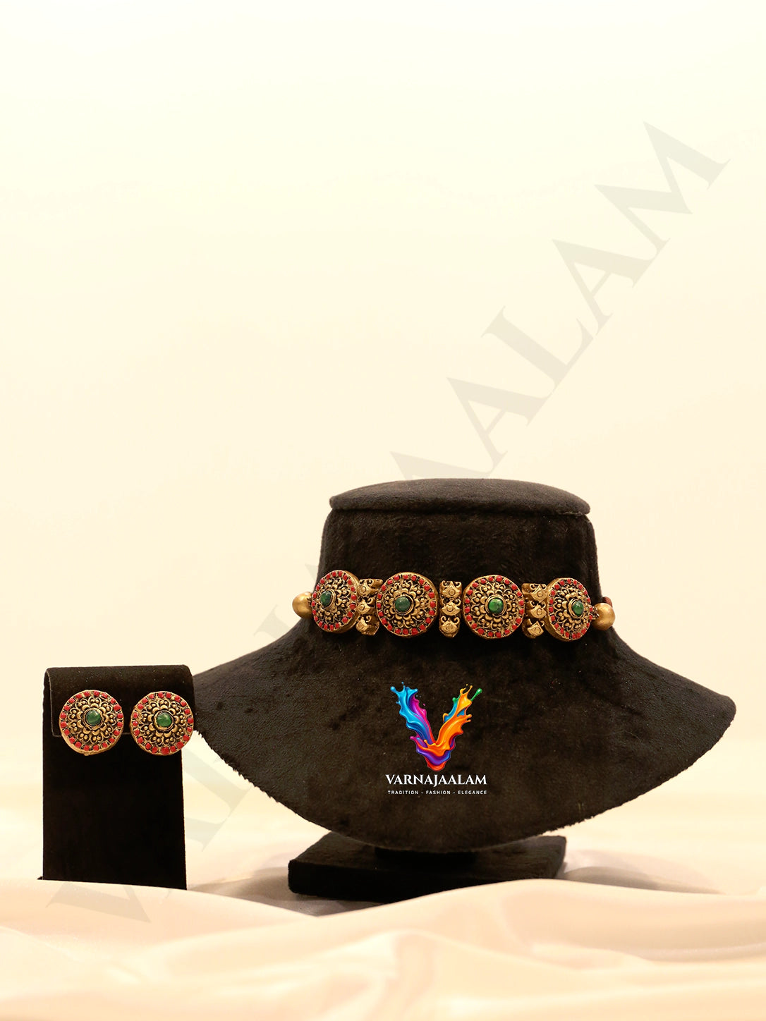 Terracotta choker with red and green chakra wheel medallions, antique gold motifs, and matching round stud earrings