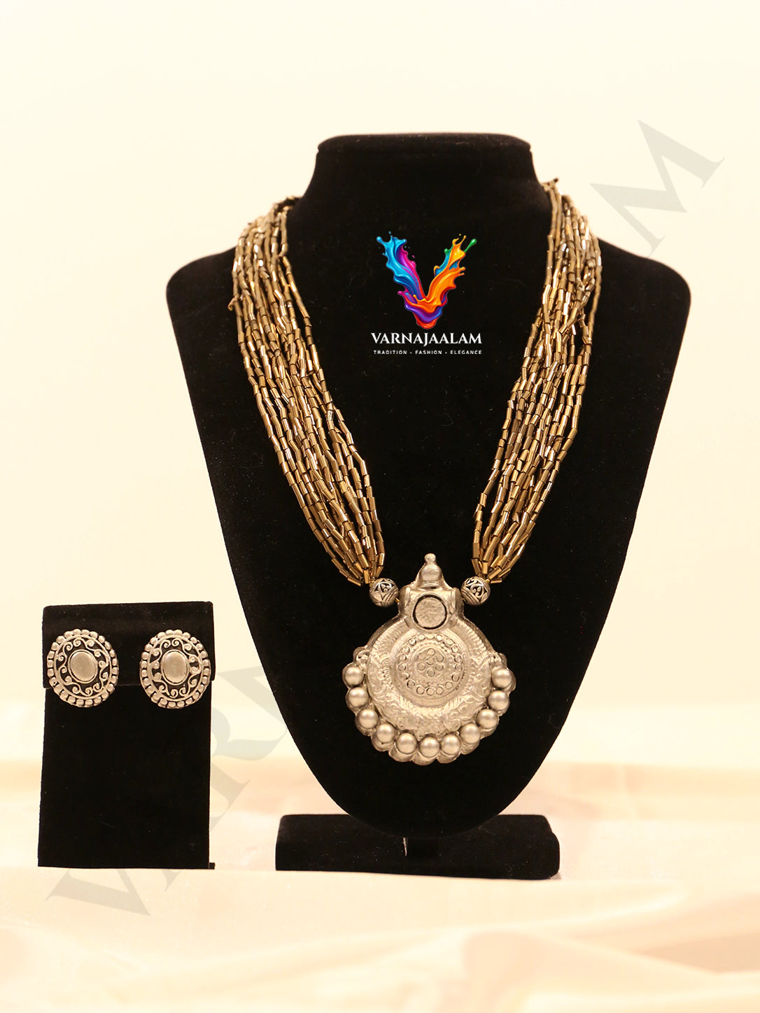 Multi-strand tube glass bead mala necklace featuring an oxidized silver terracotta pendant and matching terracotta stud earrings