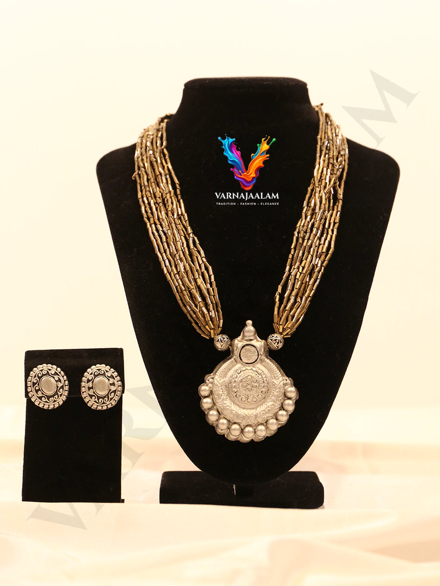 Multi-strand tube glass bead mala necklace featuring an oxidized silver terracotta pendant and matching terracotta stud earrings
