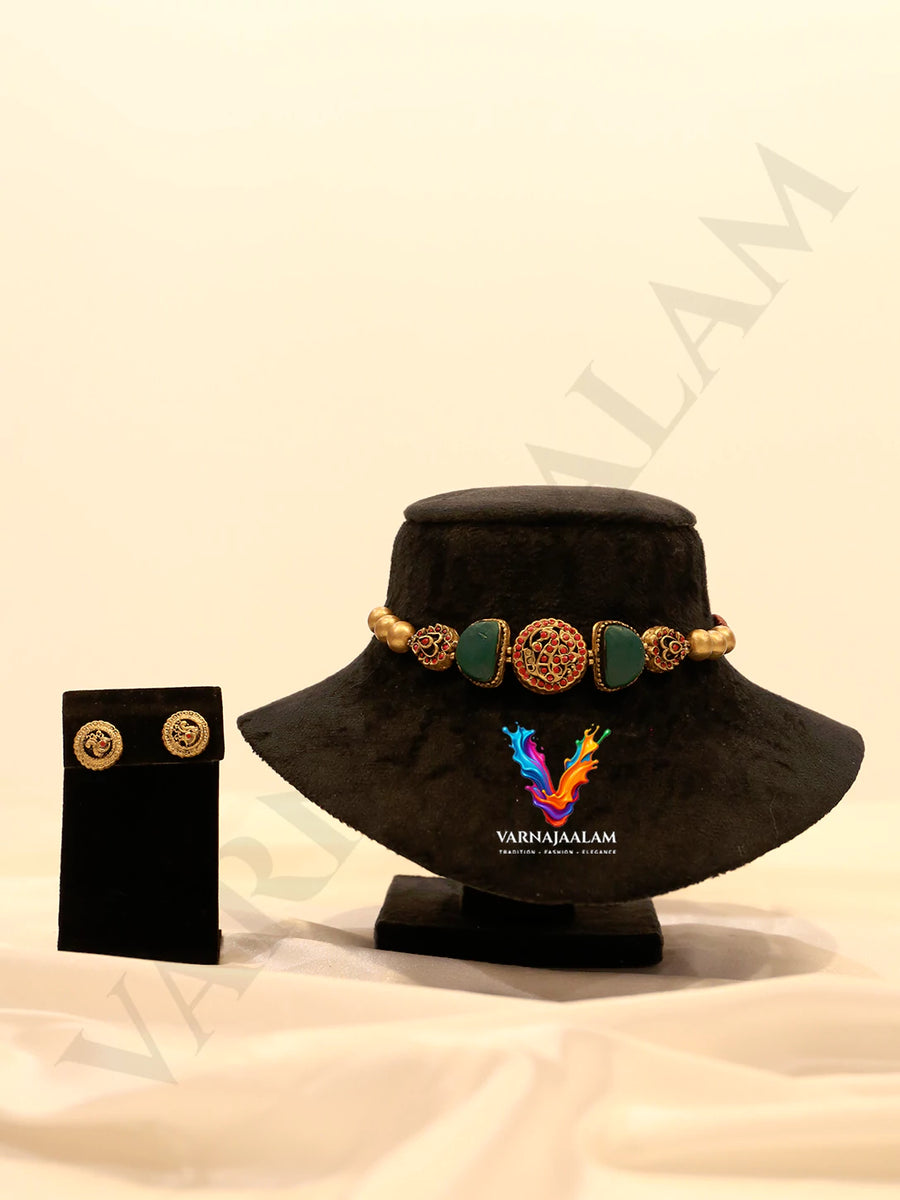 Handcrafted terracotta choker with green half-moon beads, red beaded central medallion, gold accents, and matching round stud earrings