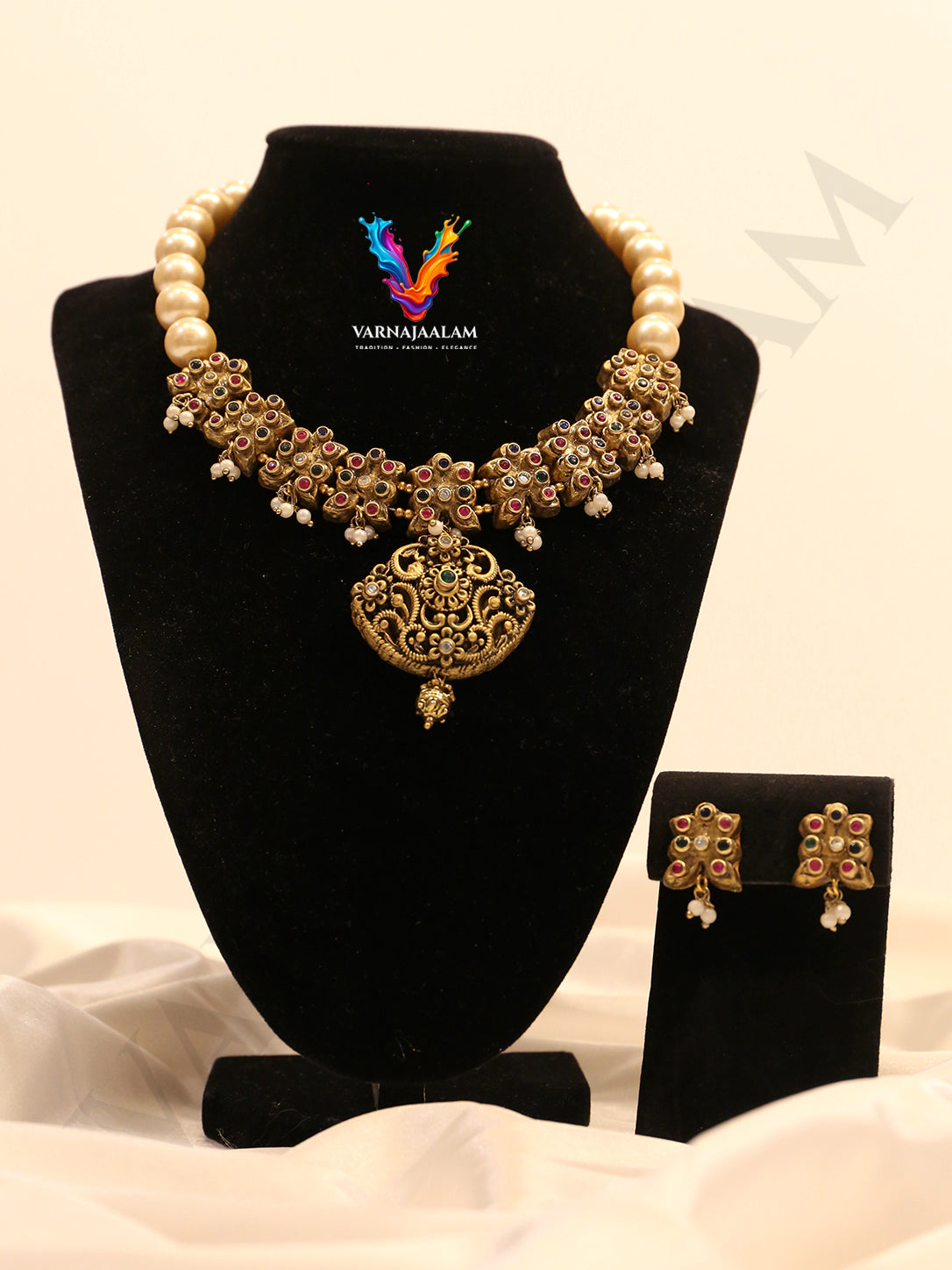 Terracotta cream pearl choker with multi-color floral motif band, pendant, and matching earrings