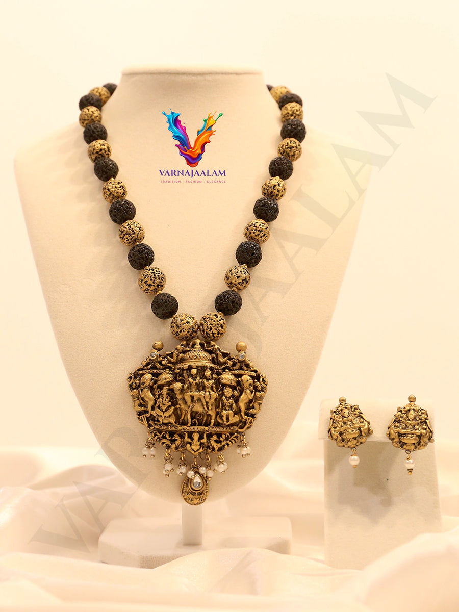 Terracotta long mala with textured black and gold beads, antique temple pendant, and matching earrings