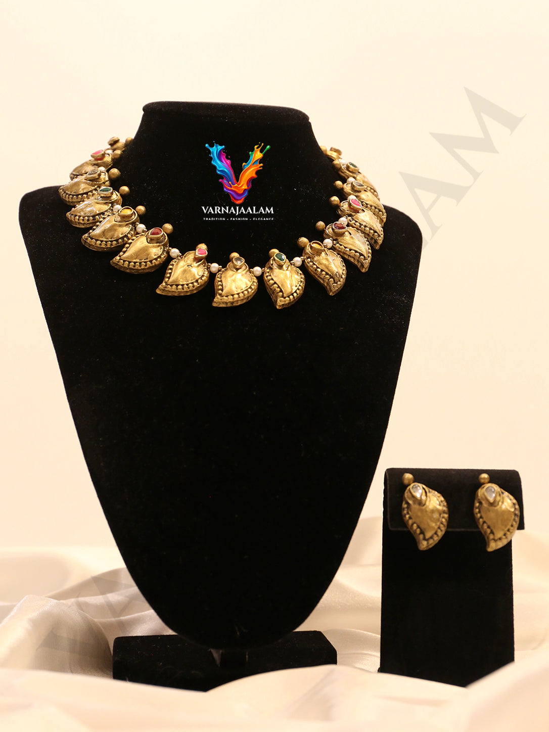 Terracotta gold-toned manga motif necklace with gem accents and matching manga stud earrings