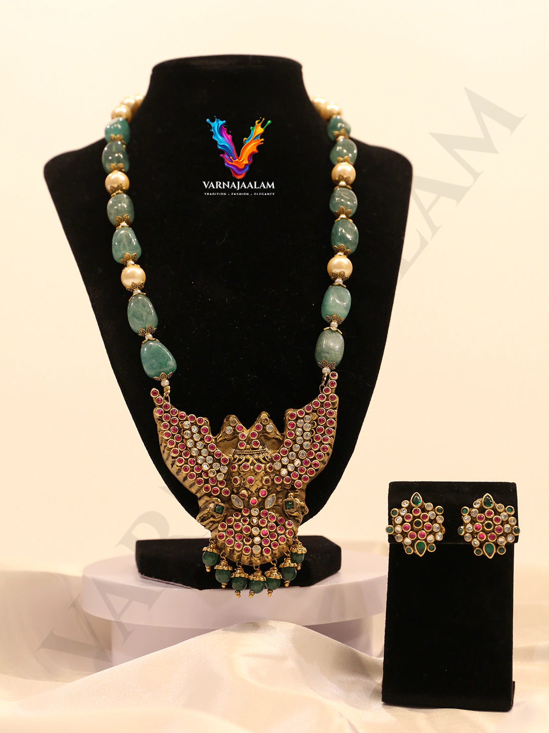 Terracotta long mala with green tumble stones and pearls, featuring a ruby-studded Gandaberunda pendant and matching flower studs