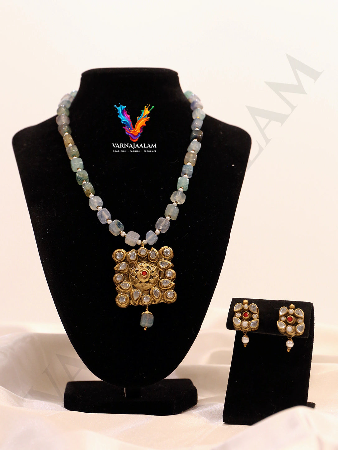 Terracotta long mala with icy seafoam blue tumbled beads, antique gold Kundan stone-studded square medallion pendant, and matching earrings