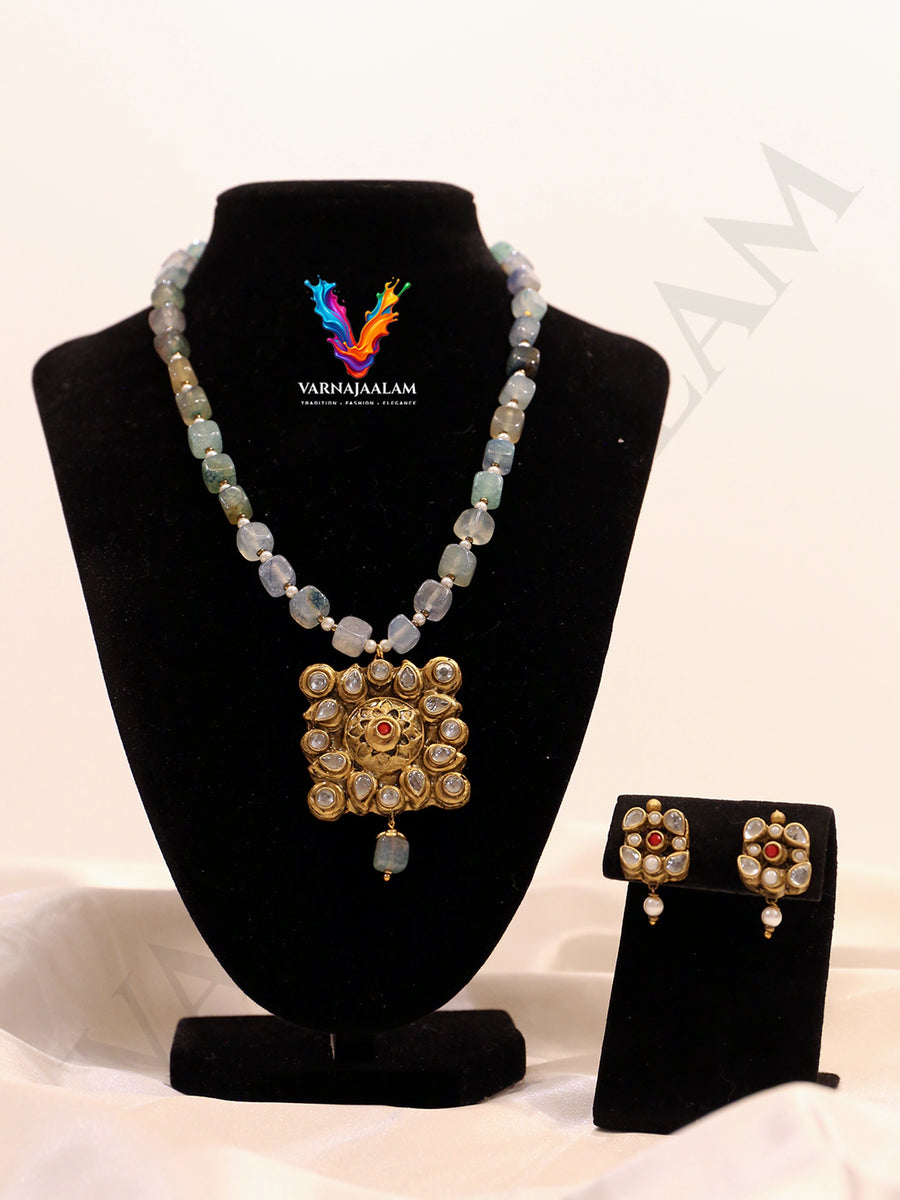 Terracotta long mala with icy seafoam blue tumbled beads, antique gold Kundan stone-studded square medallion pendant, and matching earrings