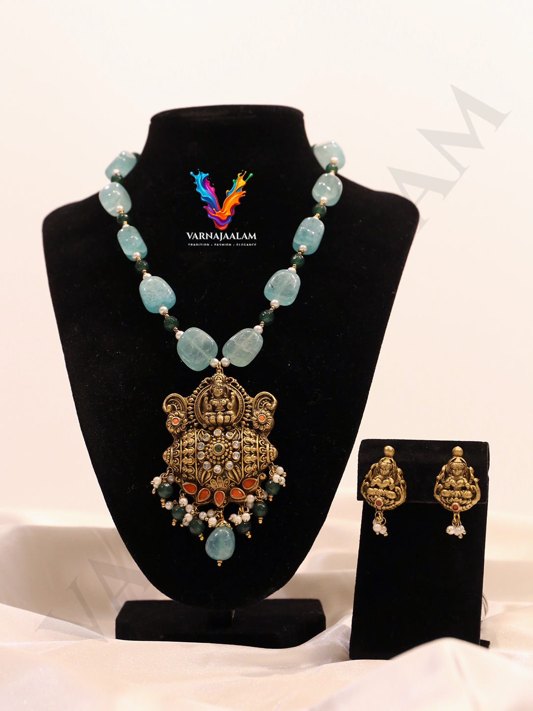 Terracotta long mala with smooth seafoam aqua tumble beads, featuring an intricate antique Lakshmi temple pendant with pearl-and-bead fringe, with matching Lakshmi stud earrings.