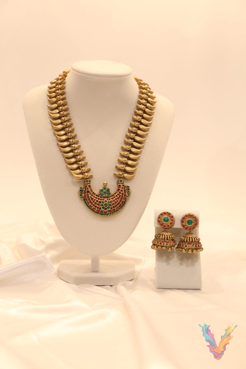 Gold terracotta necklace with a green stone pendant and earrings